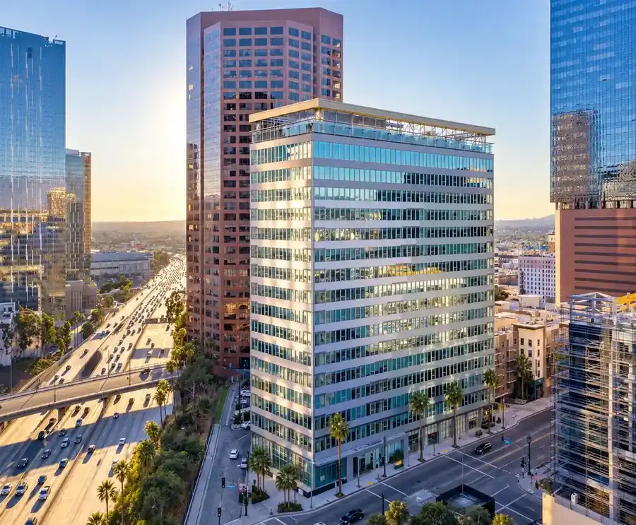 Office tower overlooking a major urban freeway corridor at sunset