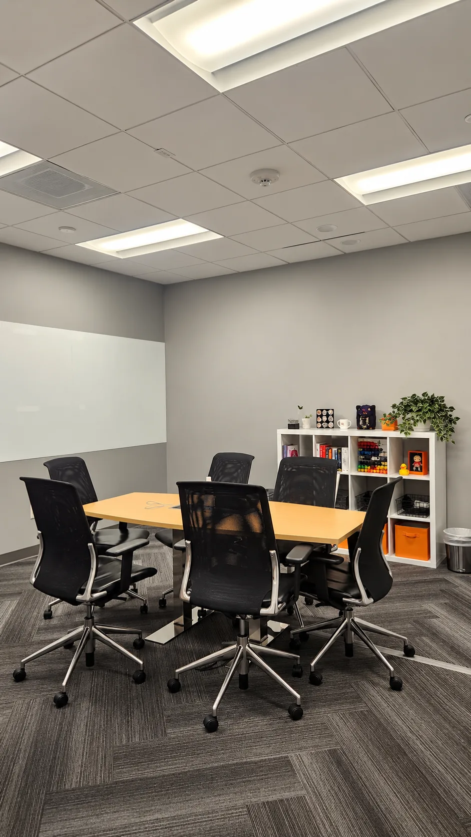 Suite 250 conference room with seating for six and whiteboard wall
